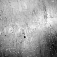 a black and white photo of a wall with writing on it
